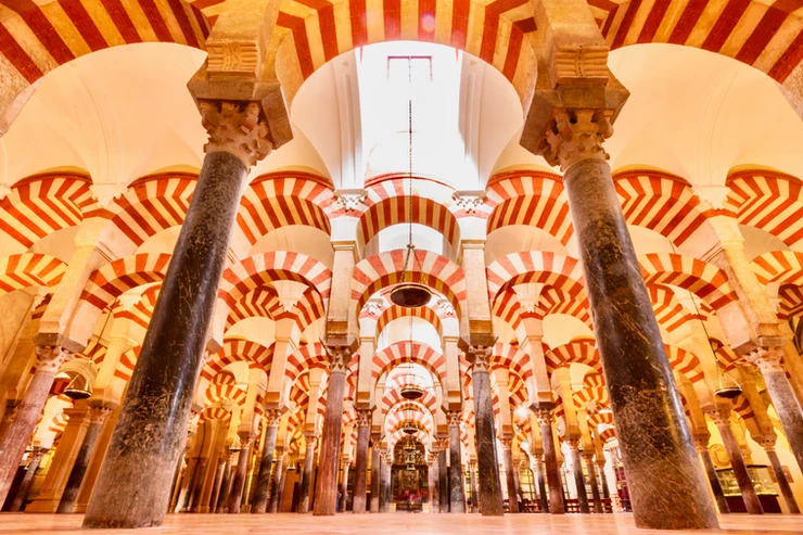 a forest of candy cane arches in the Mezquita in Cordoba, a must visit city on your 10 days in Spain itinerary
