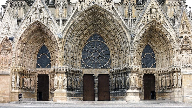 three ornate portals on the facade of Reims Cathedral