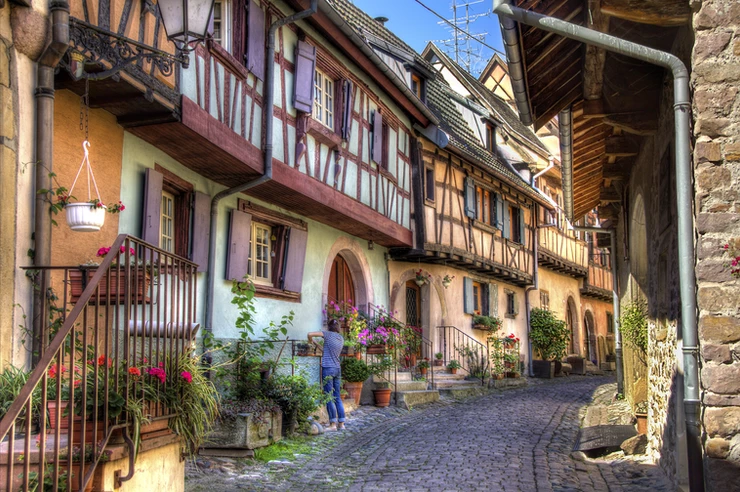 half timbered houses along a cobbled street in a typical French village
