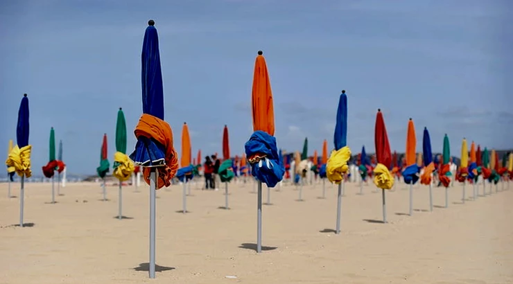 the forest of colorful umbrellas that are permanent fixtures in Deauville