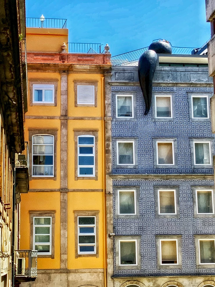blue and white tiled home in Porto with an art installation slug
