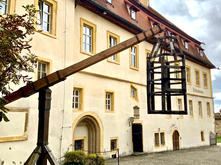 entrance to Rothenburg's medieval crime museum, with a prisoner cage to start the gruesome tour
