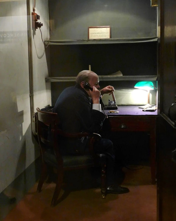 A faux Churchill in the secret transatlantic telephone room disguised as an "occupied" toilet.