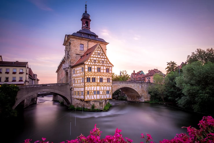 the iconic yellow timbered Town Hall of Bamberg, which seems to float above the Regnitz River