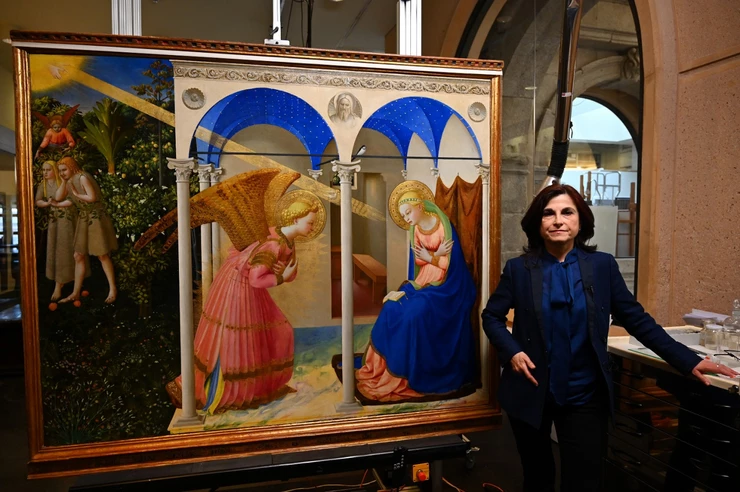 Almudena Sanchez, Prado restorer poses next to the restored Annunciation (AFP/Gabriel Bouys)