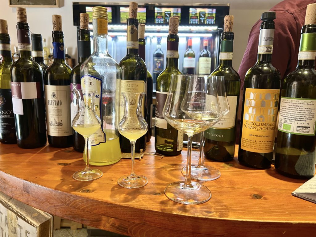 tasting Vernaccia at a local shop in San Gimignano