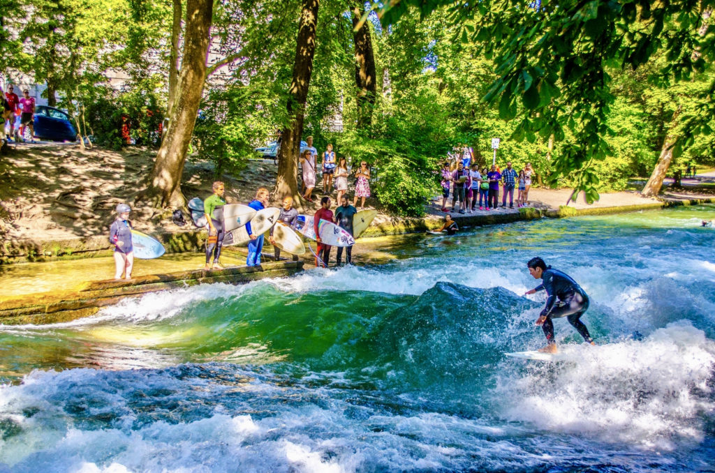 surfers on an artificial wave in the Englischer Garden