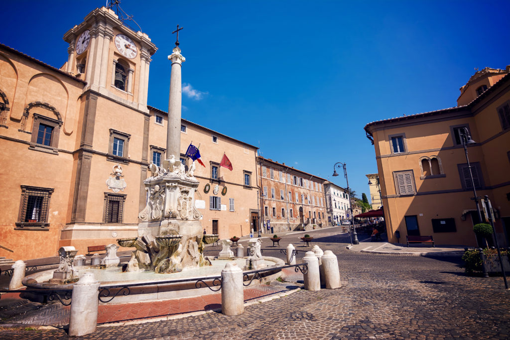 fountain and town hall in a square of Tarquinia