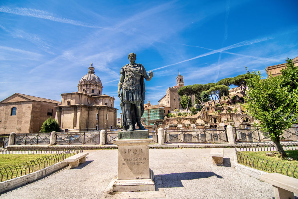 Via dei Fori Imperiali with a statue of Emperor Trajan