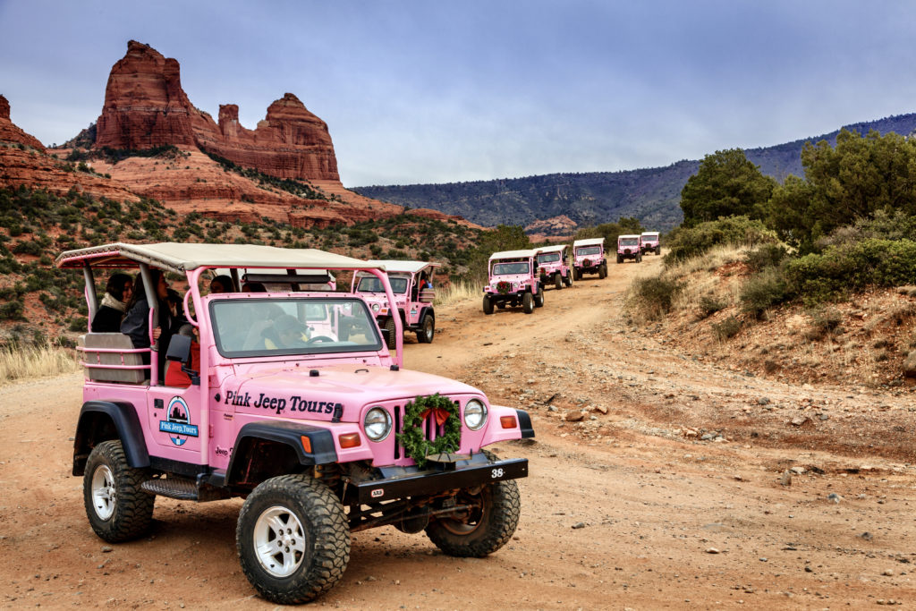 caravan of Pink Jeep Tours vehicles on Schnebly Hill Road