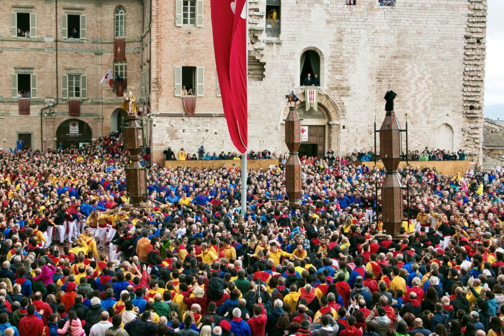 spectators watch the Race of the Candles in Piazza Grande