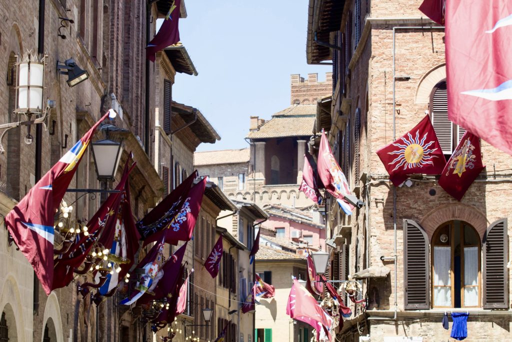 flags flying in the zone of the Contrada della Torre