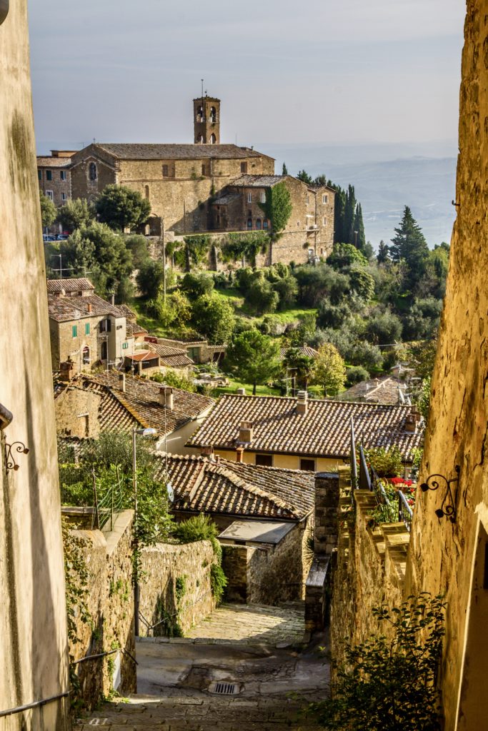 narrow street in Montalcino with a view of the fortress
