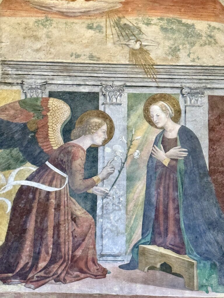 The Annunciation by Melozzo da Forli, to the right of the entrance