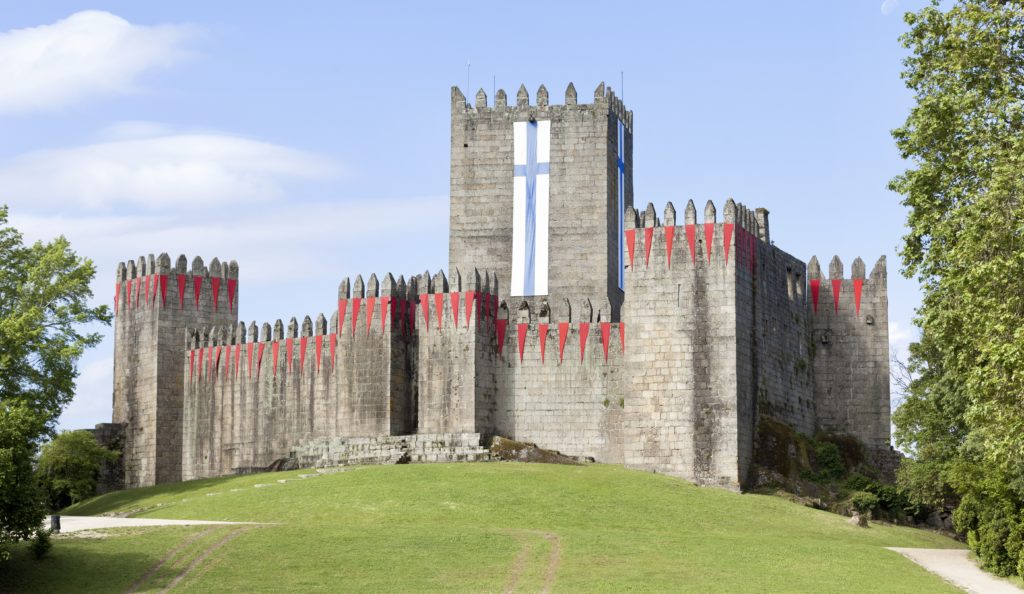Guimaraes Castle with the flag of the city
