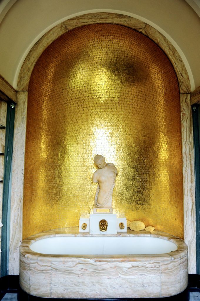 Virginia's bathroom with gold mosaic wall
