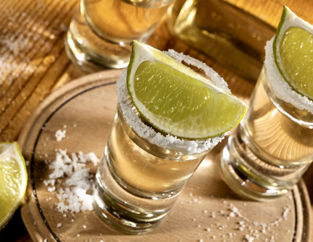 glasses of tequila with limes
