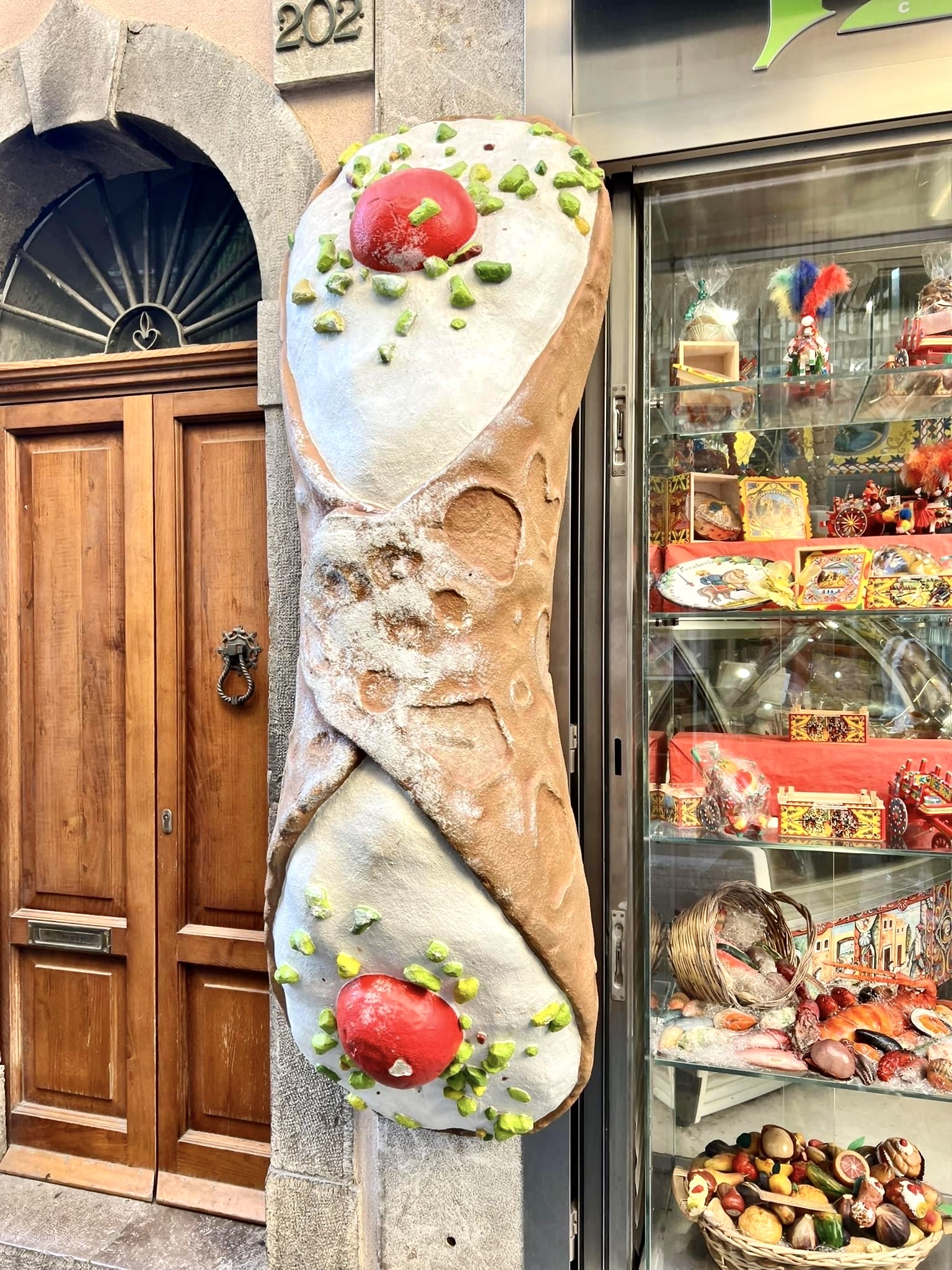 giant cannolo on storefront
