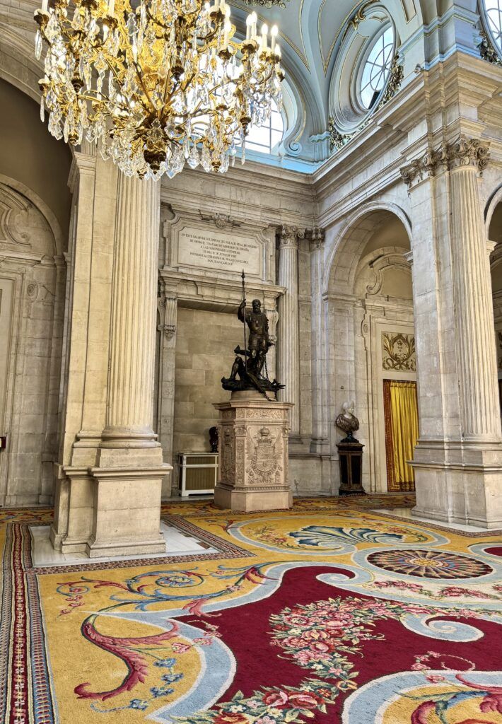 Halberdiers' Hall with elaborate carpet and chandeliers