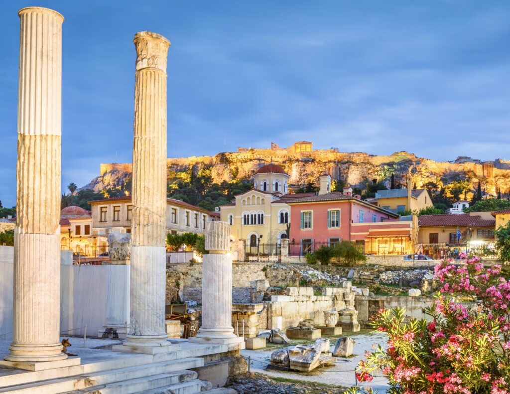 ancient ruins in Athens with the Plaka neighborhood in the background