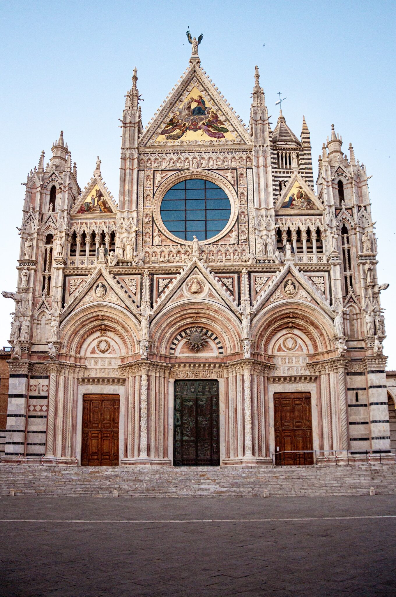 The green-and-white marble facade of Siena Cathedral