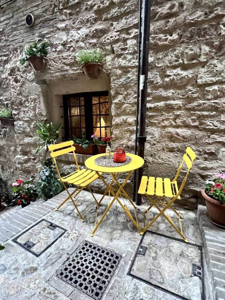 cafe chairs in a lane in Spello