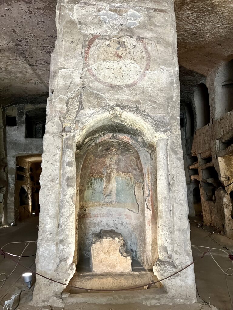 pillar with frescoed niche in the catacombs