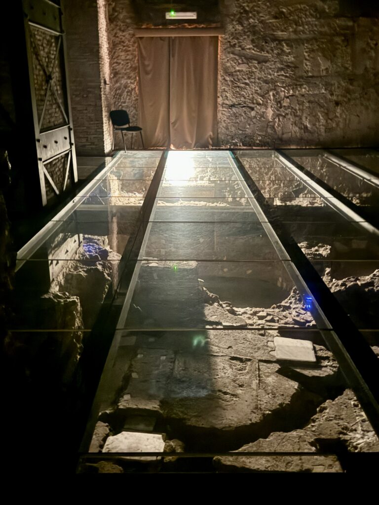 glass walkway covering ruins