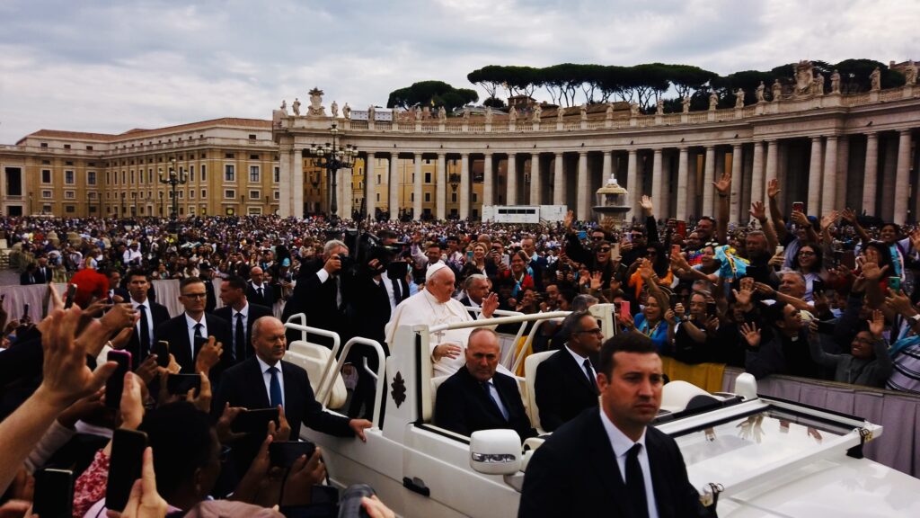 Pope Francis in the popemobile blessing the faithful 
