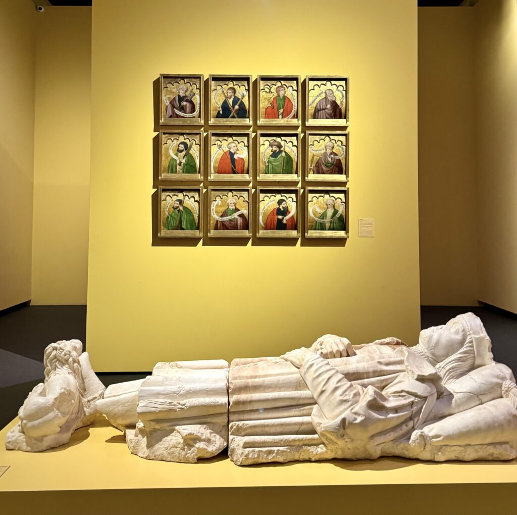 recumbent effigy in front of the Apostolate series