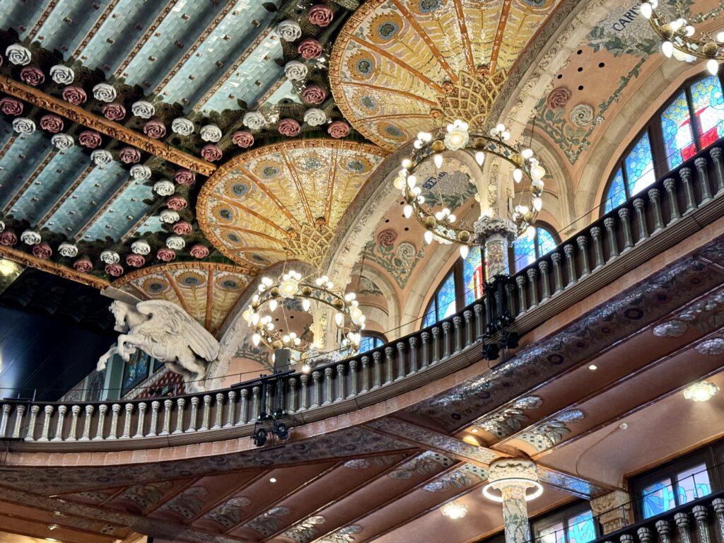 view of ceiling and tilted chandeliers