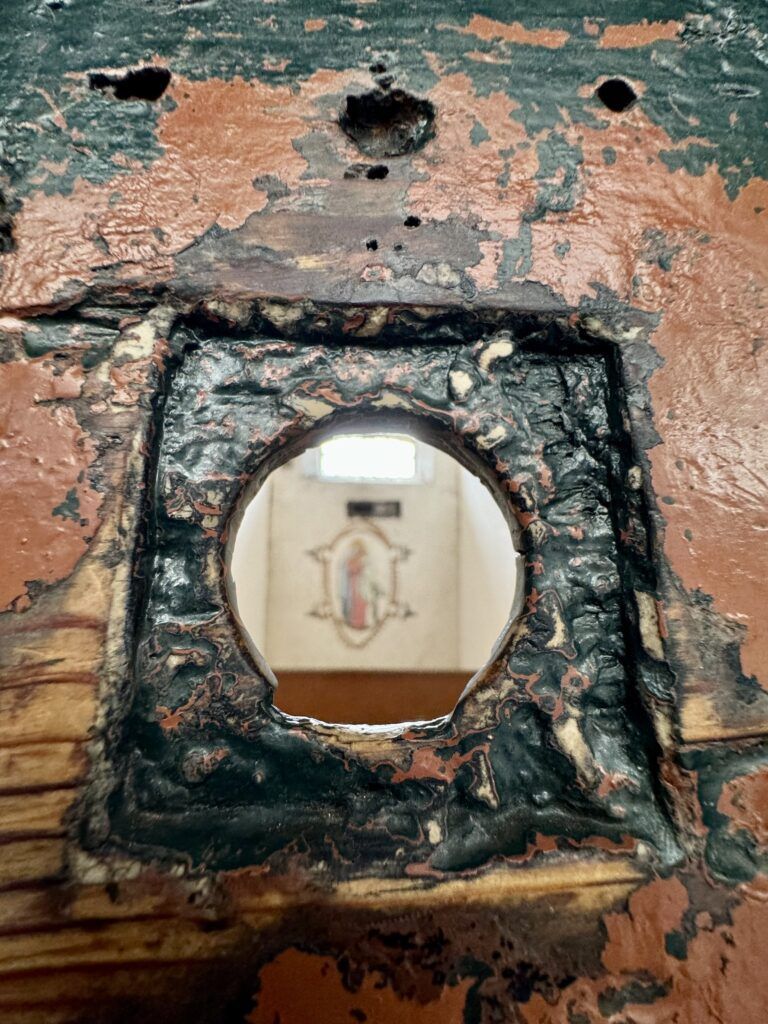 spy hole into Grace's cell