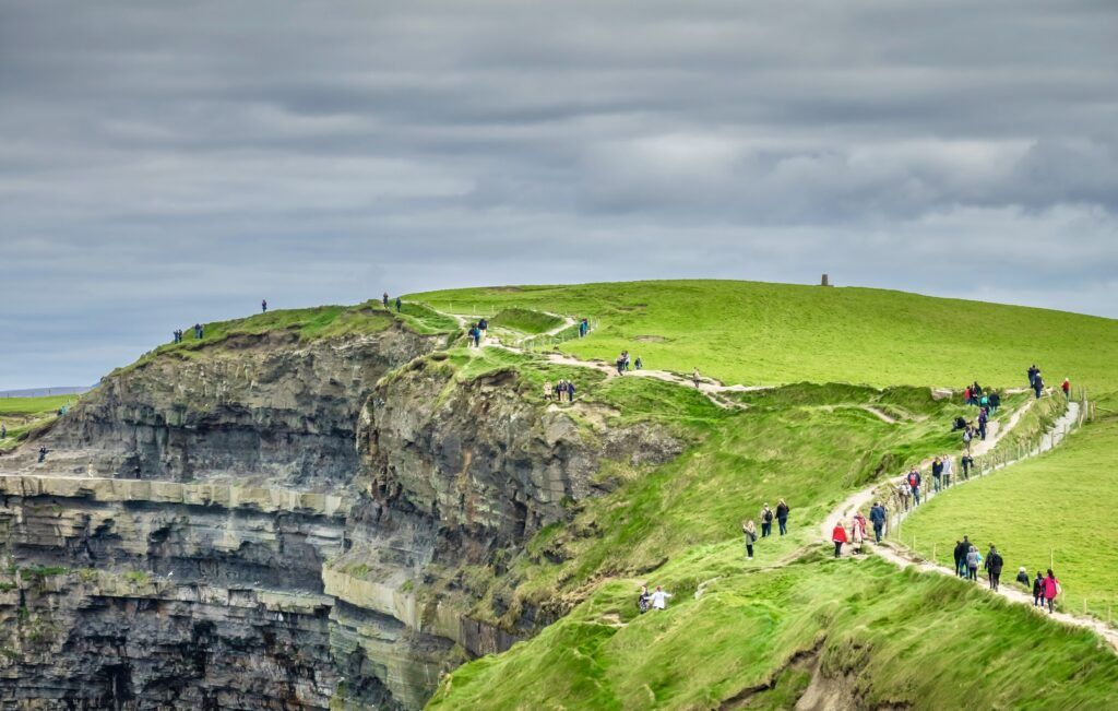 People walking on the path at the Cliffs of Moher