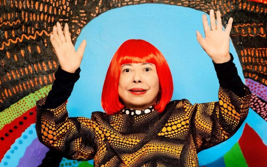 photograph of Kusama with one of her My Eternal Soul paintings