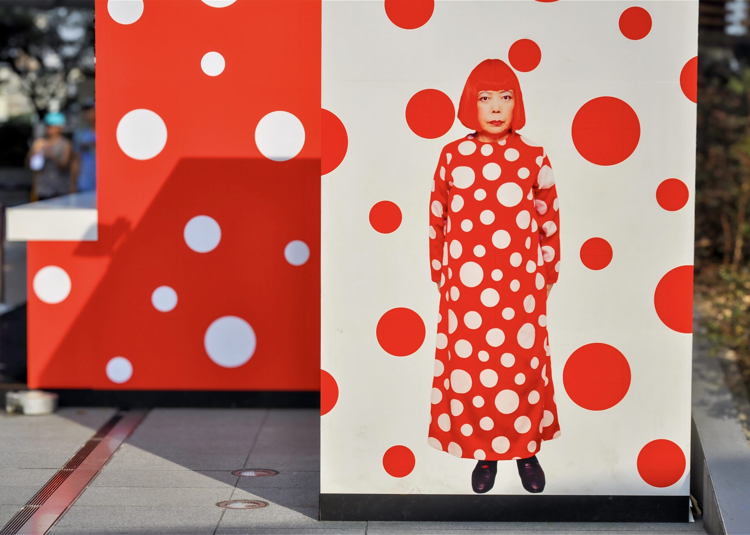 Kusama wearing her iconic red and white polka dot dress, 2013