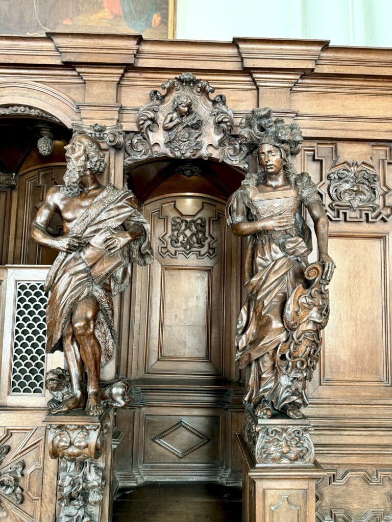 confessional with carved wood figures