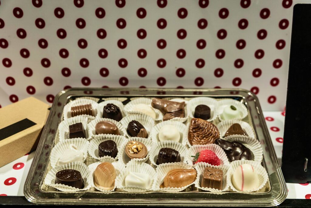 Assortment of traditional belgian chocolate in the shop window of a candy shop in the old town of the medieval city of Ghent, Belgium