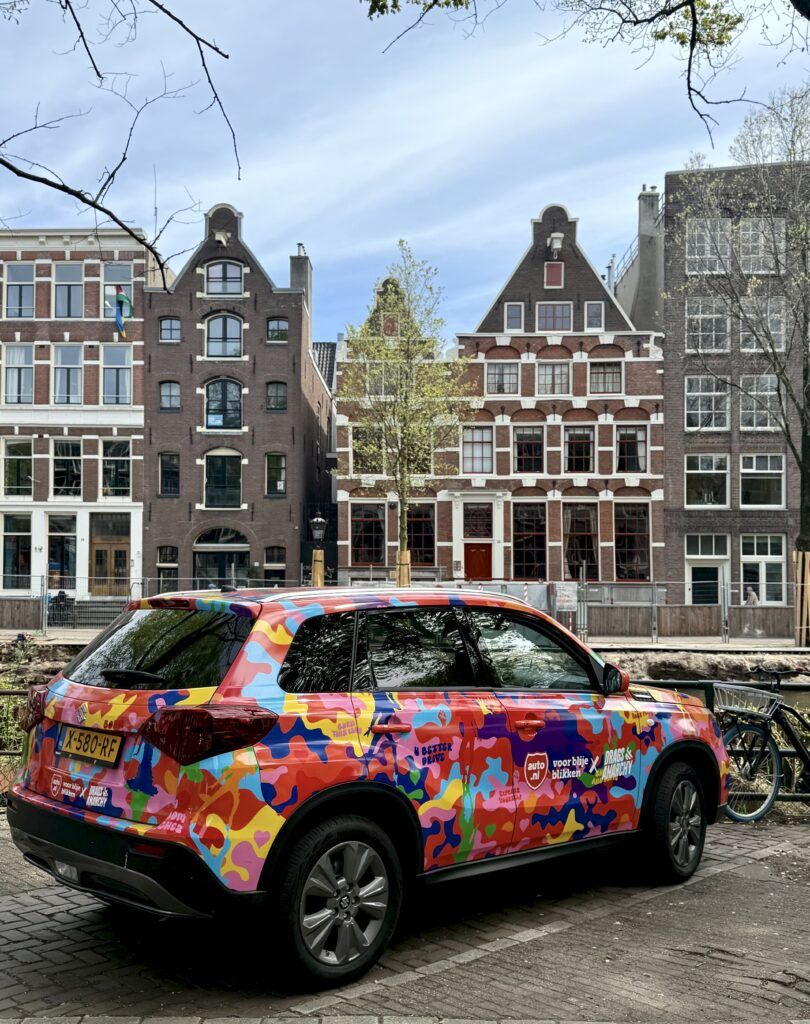 painted car on a canal in Amsterdam