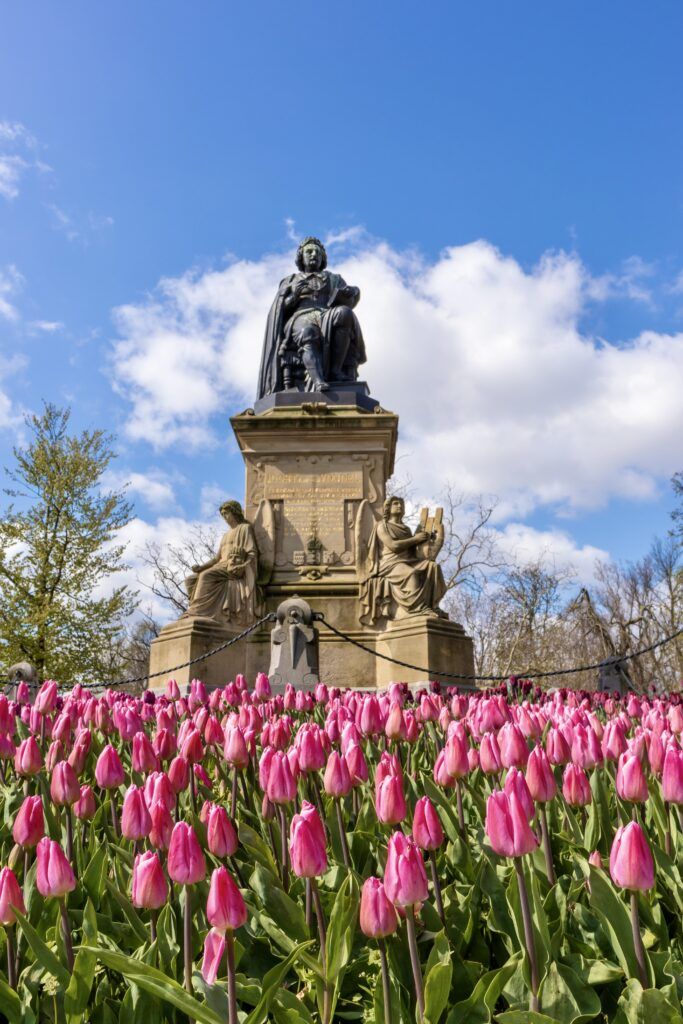 Vondelpark with a sculpture and tulips blooming