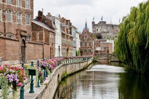 view of a canal in Ghent with beautiful architecture ad Gravensteen Castle