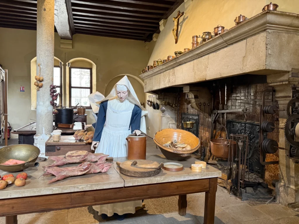 Mitch with a large Gothic fireplace