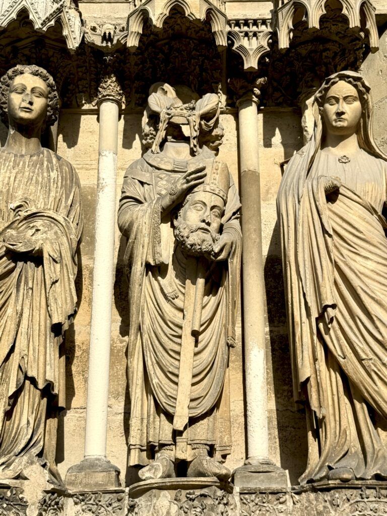sculpture of Saint Denis holding his head in the center
